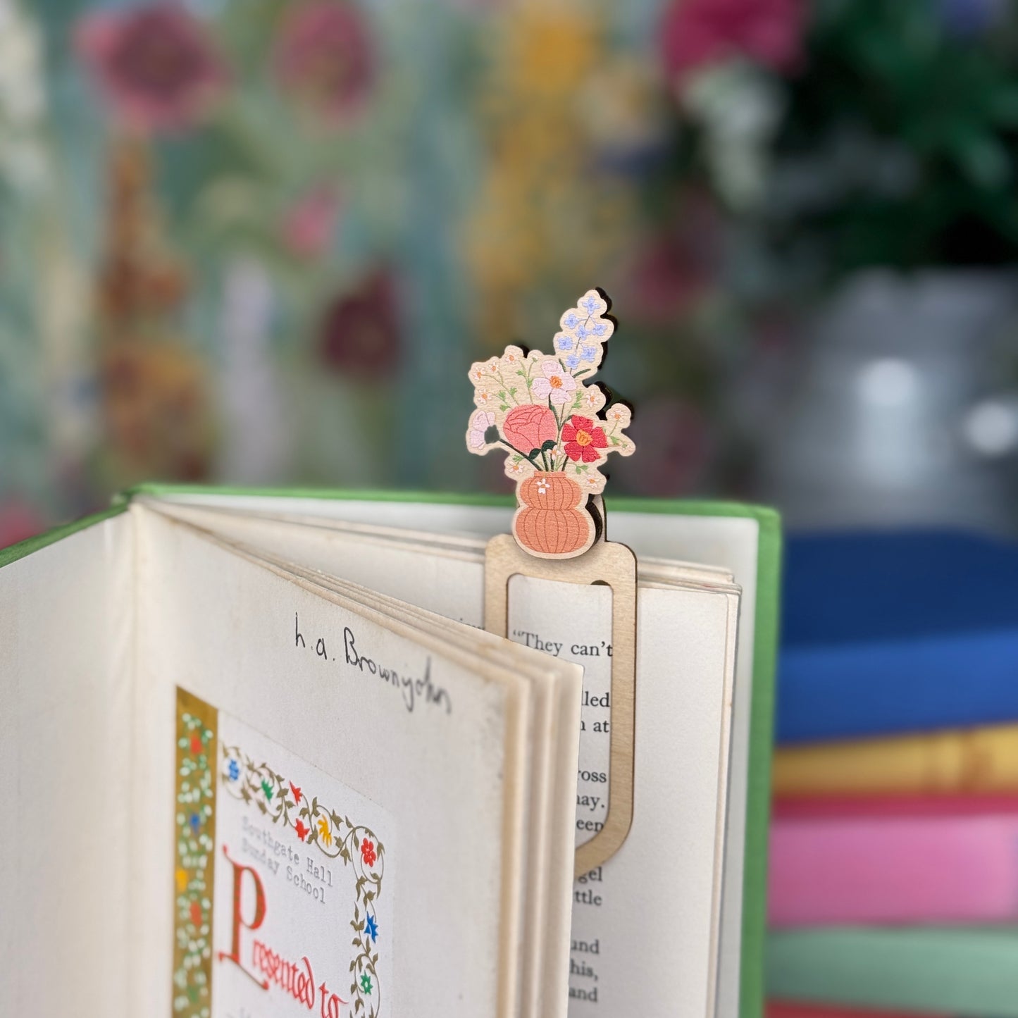 Floral bookmark on a book with a blurred floral background